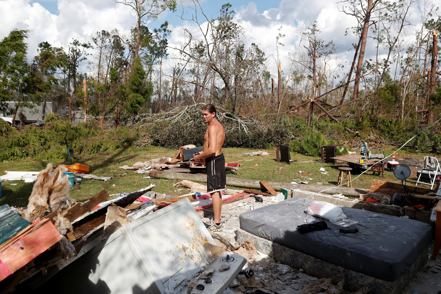 Gabriel Schaw stands in the remains of his destroyed home Oct. 16 in the aftermath of Hurricane Michael in Fountain, Fla. The hurricane killed at least 16 people in Florida, most of them in the coastal county that took a direct hit from the storm, state emergency authorities said. That’s in addition to at least 10 deaths elsewhere across the South.